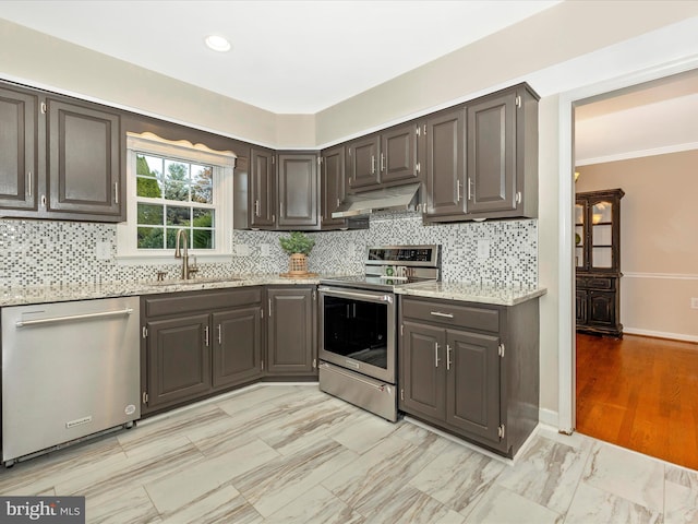 kitchen with decorative backsplash, crown molding, sink, and appliances with stainless steel finishes