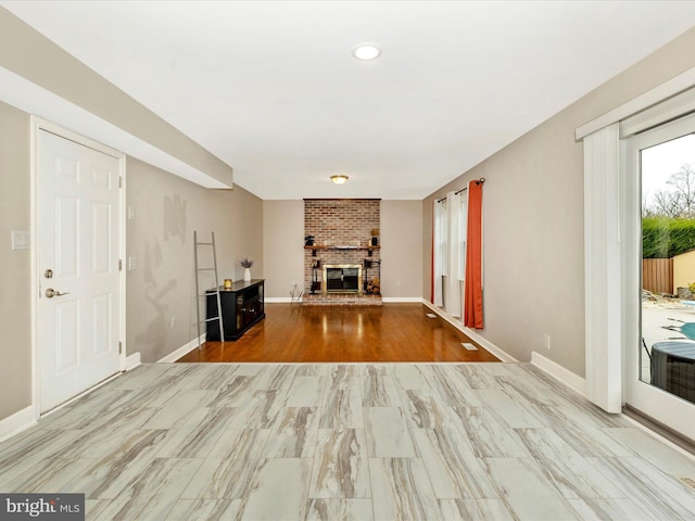 unfurnished living room with a fireplace and light hardwood / wood-style flooring