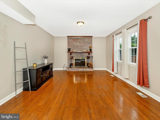 unfurnished living room with a fireplace and hardwood / wood-style floors