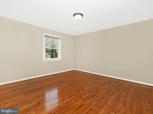 spare room with wood-type flooring