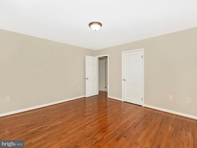 unfurnished room with wood-type flooring