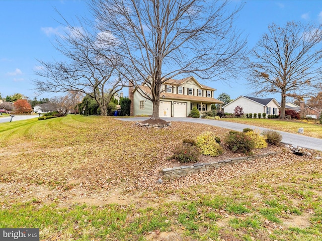 view of front of home with a front yard and a garage