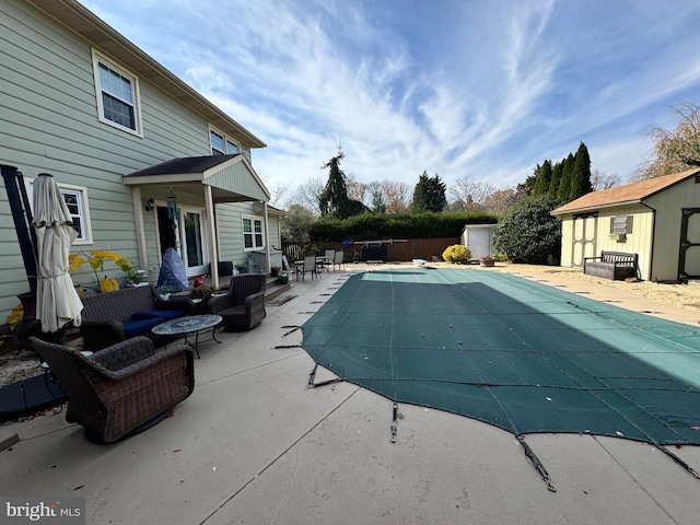 view of swimming pool featuring an outdoor hangout area, a patio, and a shed