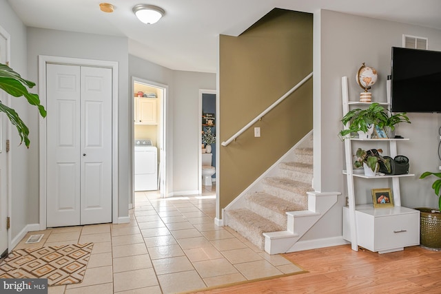 entryway featuring light wood-type flooring and washer / clothes dryer