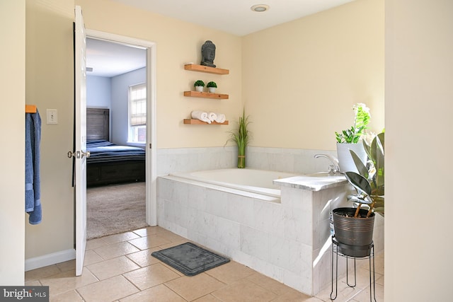 bathroom featuring a relaxing tiled tub and tile patterned flooring