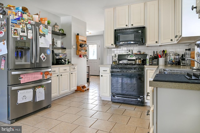 kitchen featuring white cabinets, sink, black appliances, and tasteful backsplash