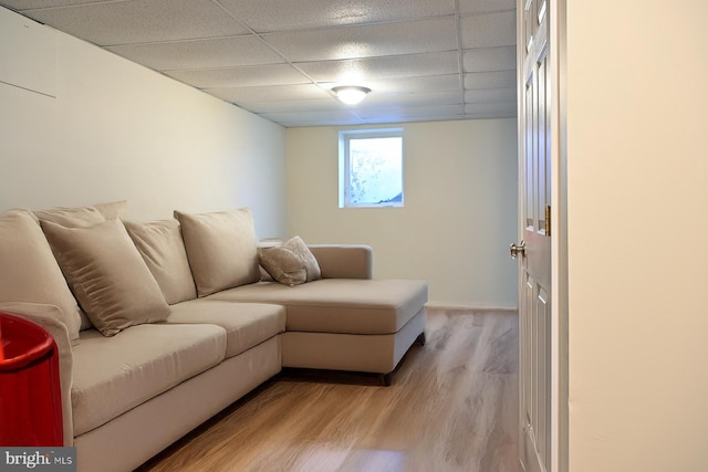 living room featuring light hardwood / wood-style floors and a paneled ceiling