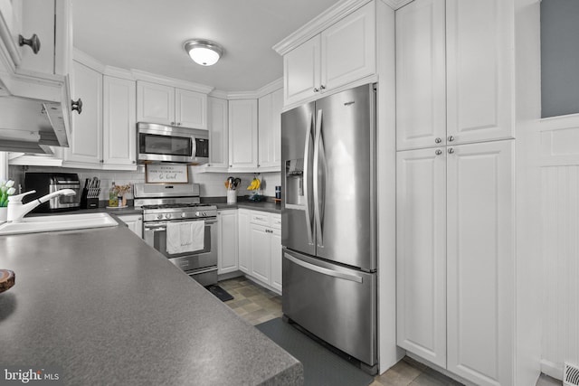 kitchen featuring white cabinetry, sink, and appliances with stainless steel finishes