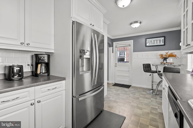 kitchen with white cabinetry, appliances with stainless steel finishes, and crown molding