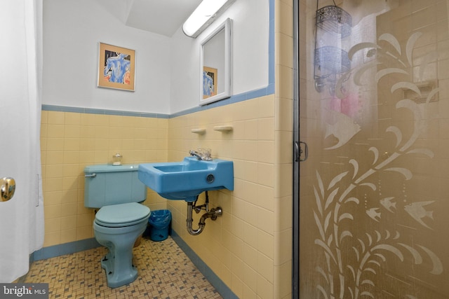 bathroom featuring walk in shower, tile patterned floors, toilet, and tile walls