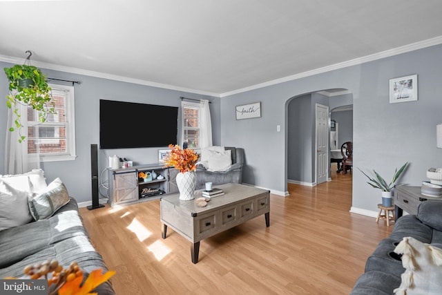 living room with ornamental molding and light hardwood / wood-style floors