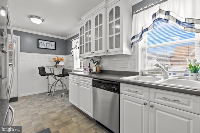 kitchen featuring dishwasher, decorative backsplash, white cabinets, sink, and crown molding