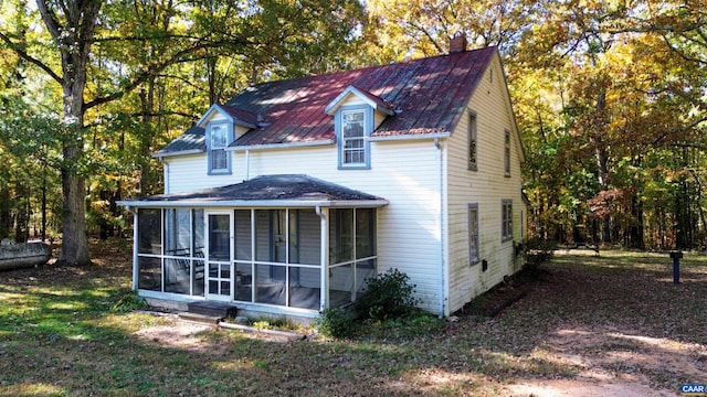 back of house featuring a sunroom