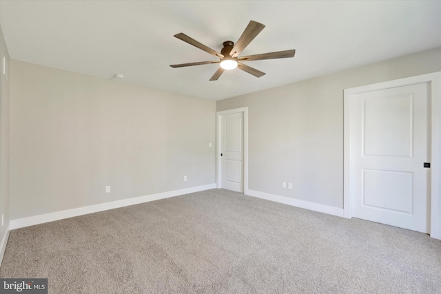 empty room featuring carpet and ceiling fan