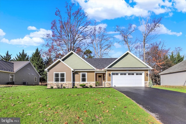 view of front facade with a garage, central AC, and a front lawn