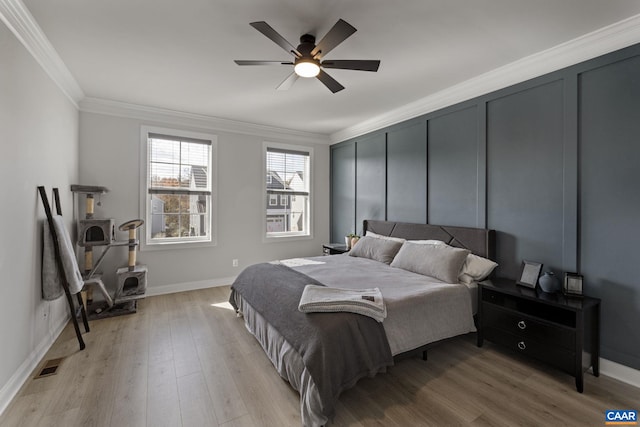 bedroom featuring light wood-type flooring, ceiling fan, and crown molding