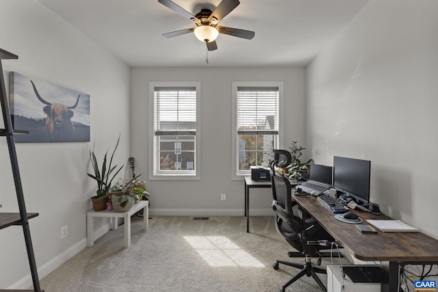 carpeted office featuring ceiling fan