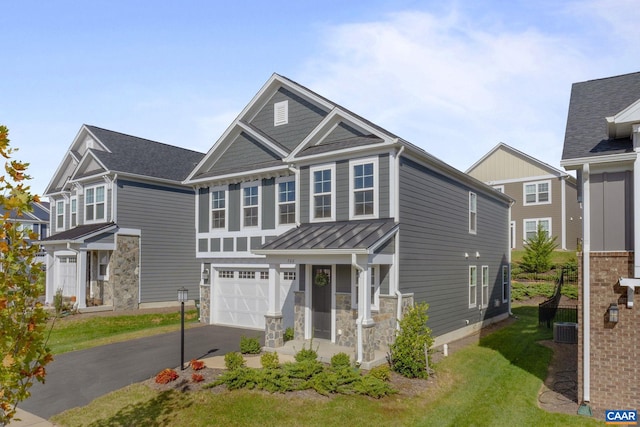 view of front of property featuring a garage and central AC