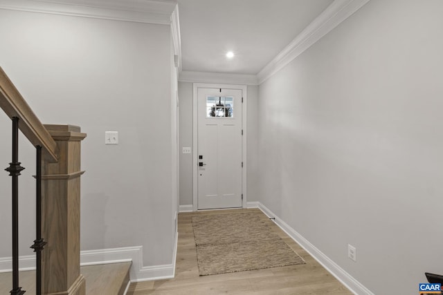 doorway featuring light wood-type flooring and ornamental molding