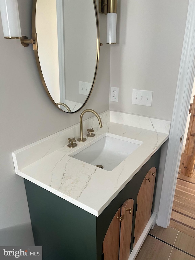 bathroom with hardwood / wood-style flooring and vanity