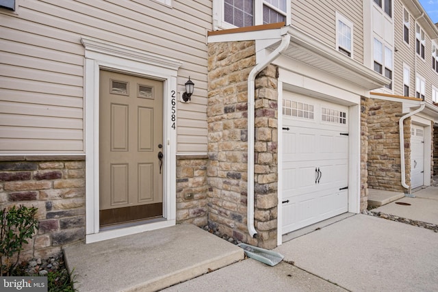 doorway to property with a garage