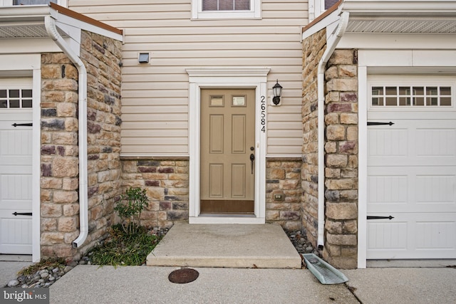 doorway to property featuring a garage