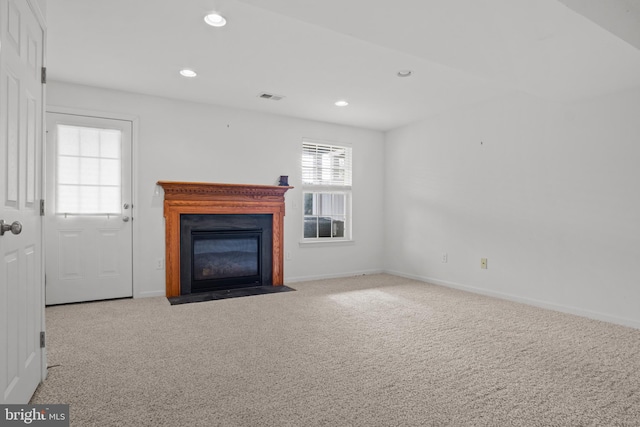 unfurnished living room featuring light carpet