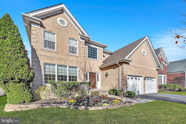 view of property featuring a front lawn and a garage