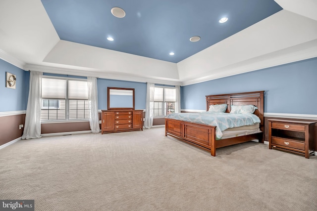 carpeted bedroom with a tray ceiling