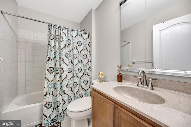 full bathroom featuring vanity, shower / bath combo with shower curtain, and toilet