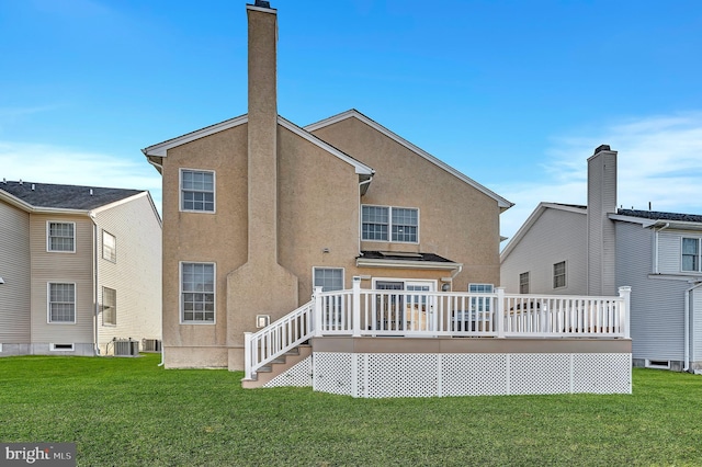 back of house featuring central AC unit, a lawn, and a wooden deck