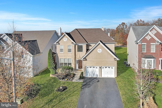 view of property featuring a garage and a front yard