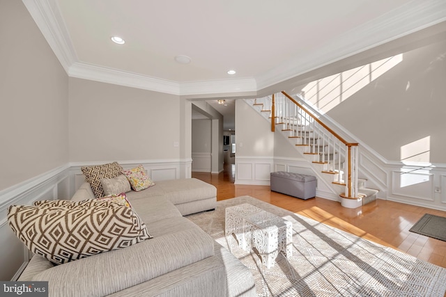 living room featuring ornamental molding and light hardwood / wood-style flooring