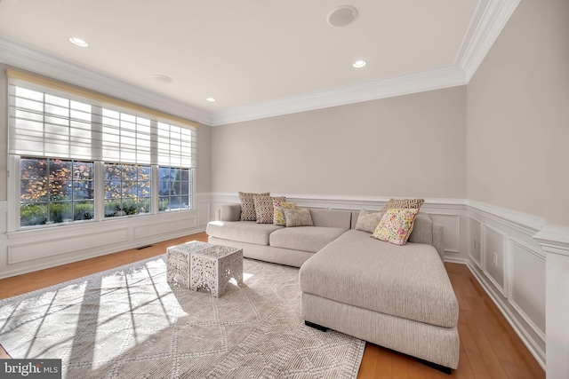 living room featuring ornamental molding and light wood-type flooring