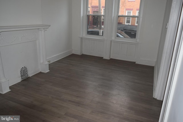 unfurnished living room featuring dark wood-type flooring