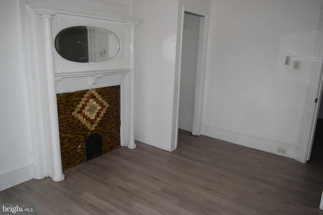 unfurnished living room featuring dark wood-type flooring