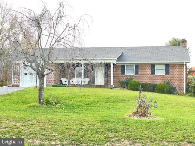 ranch-style home with a front lawn and a garage