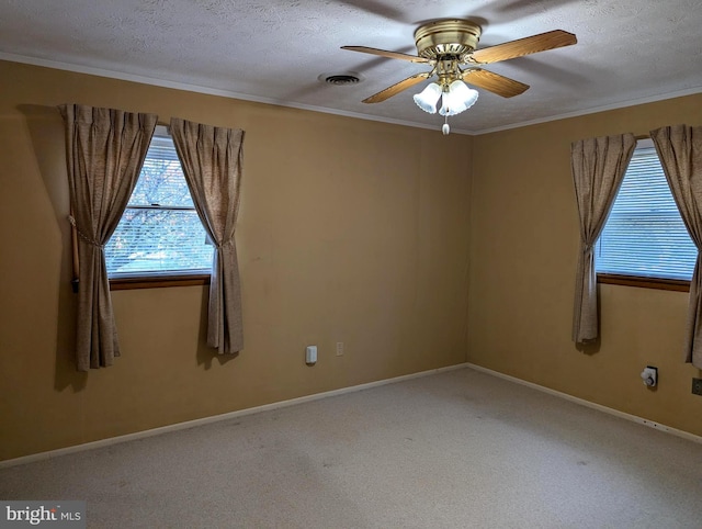 carpeted spare room featuring a textured ceiling, ornamental molding, and ceiling fan