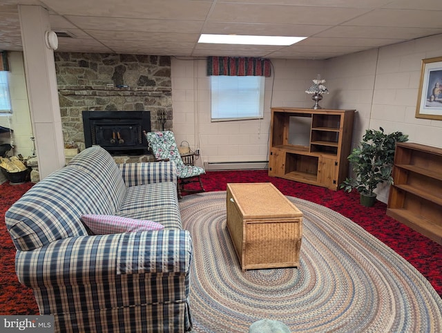 living room with a fireplace, a paneled ceiling, carpet flooring, and a baseboard heating unit