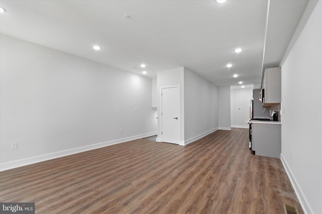 unfurnished living room featuring hardwood / wood-style flooring