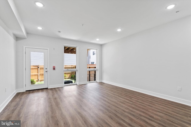 unfurnished living room with dark hardwood / wood-style flooring