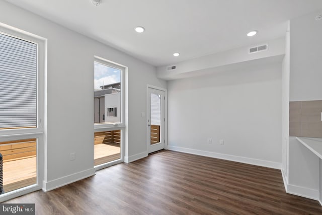 unfurnished room featuring dark hardwood / wood-style floors