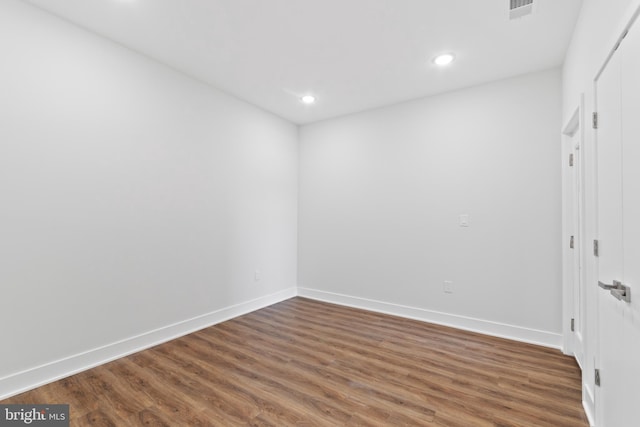 spare room with dark hardwood / wood-style floors