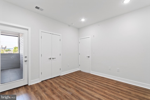 unfurnished bedroom featuring dark hardwood / wood-style floors