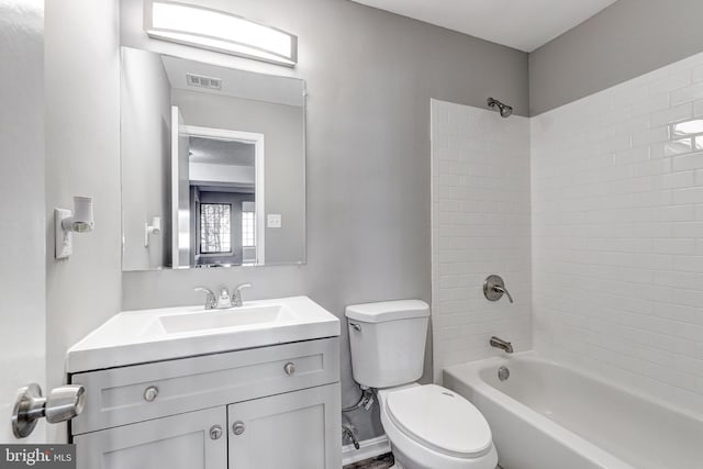 full bathroom featuring toilet, tiled shower / bath combo, and vanity