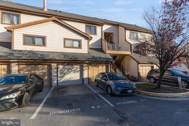 townhome / multi-family property featuring a garage and a balcony