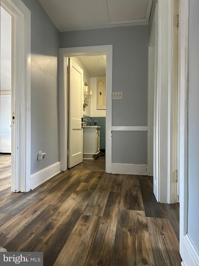 corridor featuring sink and dark hardwood / wood-style floors