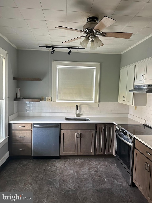 kitchen featuring ornamental molding, backsplash, appliances with stainless steel finishes, sink, and ceiling fan