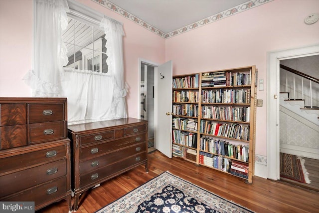 sitting room with dark wood-type flooring