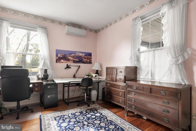 office featuring a wall mounted AC and wood-type flooring